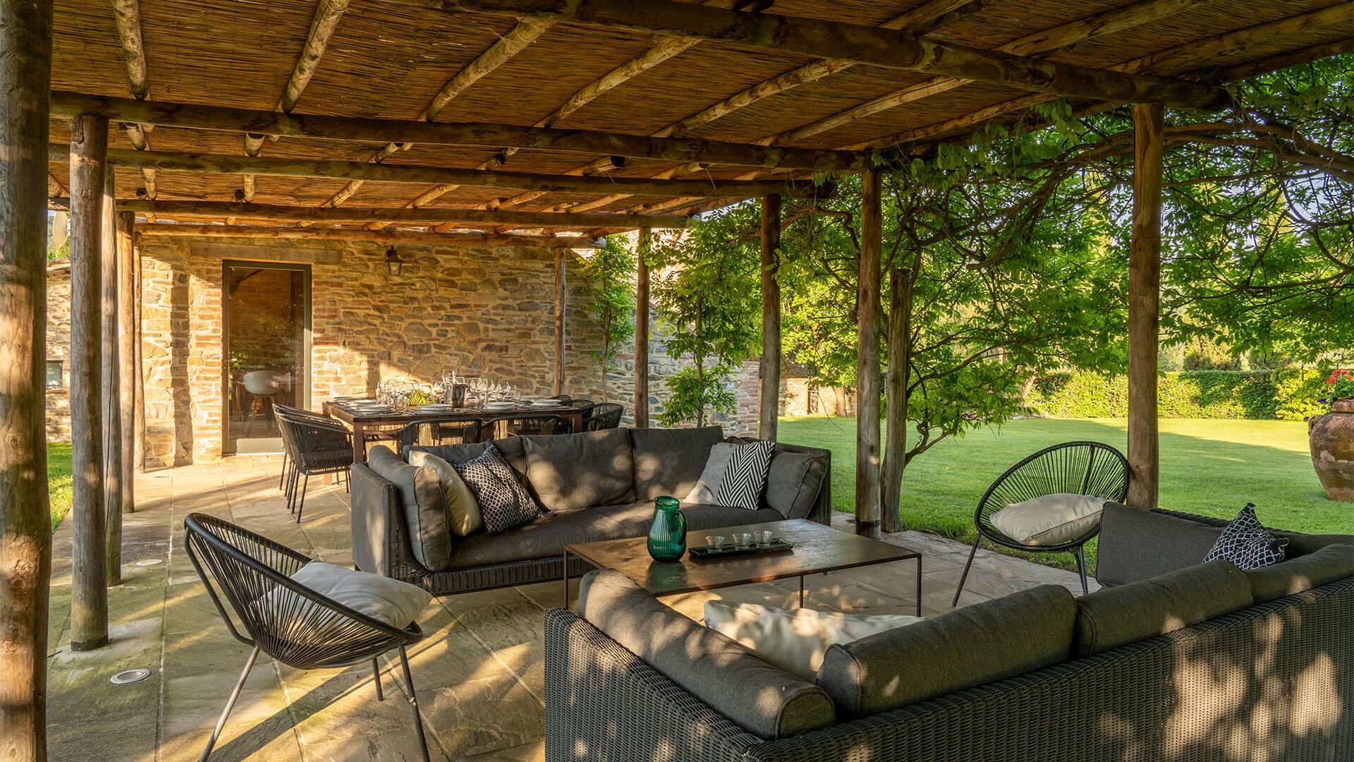 covered al fresco dining surrounded by majestic garden